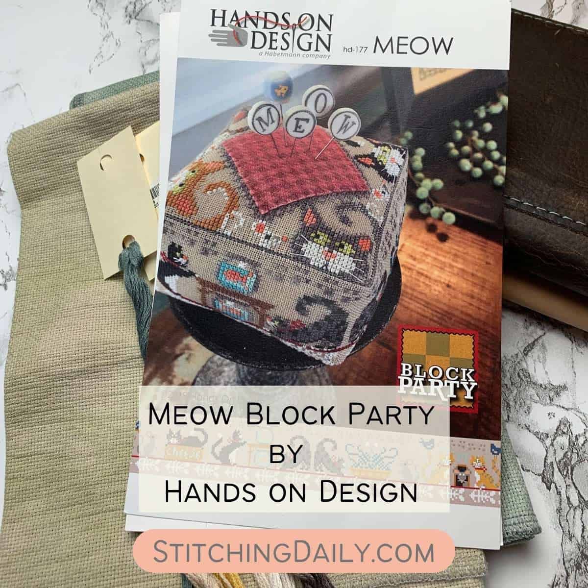 Meow Block Party Pattern on a piece of fabric with threads